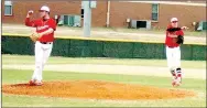  ?? MARK HUMPHREY ENTERPRISE-LEADER ?? Farmington pitcher Tyler Gregg (left) and third baseman Ryan Larkin both appear to be making a throw in this photo. The Cardinals won a 5A West game at Alma, 9-3, on March 28.