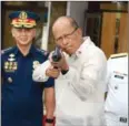  ?? ALJIBE/AFP TED ?? Philippine Defence Secretary Delfin Lorenzana holds a Chinese weapon in Manila yesterday.