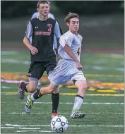  ?? PHOTO BY WALLACE BARRON ?? North Point junior Cameron Ballard Jr. dribbles down field as Chopticon sophomore Travis Jett trails from behind in Thursday’s Class 4A East Region Section II boys soccer quarterfin­al contest. Ballard scored the lone goal in the game’s 20th minute in a...