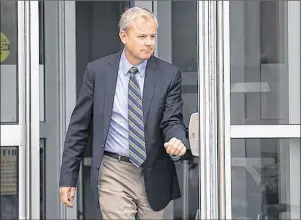  ?? CP PHOTO ?? Dennis Oland heads from Court of Queen’s Bench in Saint John, N.B., on Tuesday after a hearing to set a date for his new second-degree murder trial.