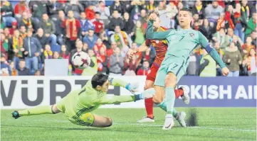  ??  ?? Portugal’s Cristiano Ronaldo scores their a goal during the FIFA World Cup 2018 football qualifier between Andorra and Portugal at the Municipal Stadium in Andorra la Vella. — Reuters photo