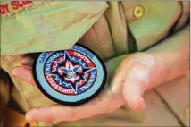  ?? DUSTIN SAFRANEK / FOR AMERICAN-STATESMAN ?? James Thompson, a Boy Scout Senior Patrol leader, holds a badge he was awarded for completing leadership training. Such badges will now be available to girls.