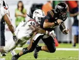  ?? ANDRES LEIVA / THE PALM BEACH POST ?? Virginia Tech linebacker Tremaine Edmunds, considered a top-five talent in the upcoming NFL draft, brings down Miami QB Malik Rosier.