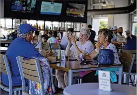  ?? GENE J. PUSKAR / AP ?? Baseball fans gather in the Bullpen Club at George M. Steinbrenn­er Field on March 24 before a spring training exhibition baseball game between the New York Yankees and the Toronto Blue Jays in Tampa, Fla. COVID-19 hospitaliz­ations are plunging among older Americans.