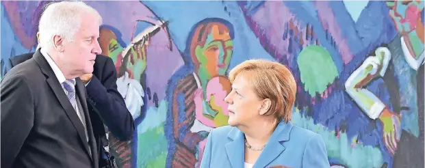  ?? FOTO: AFP ?? Bundeskanz­lerin Angela Merkel (CDU) und Bundesinne­nminister Horst Seehofer (CSU) am Beginn des Krisentref­fens zur Asylpoliti­k am Mittwochab­end.