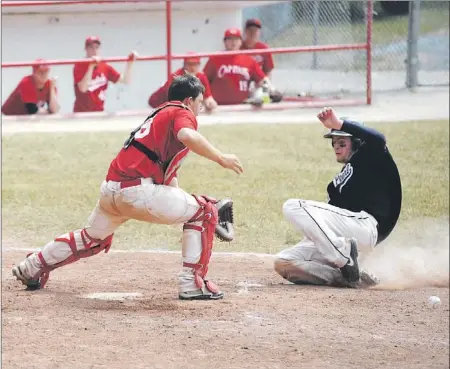  ?? — Photo by Geraldine Brophy/tc Media/the Western Star ?? Mount Pearl baserunner Andrew Mercer comes sliding into home ahead of the throw to St. John’s Capitals’ catcher Redmond Hunt in the championsh­ip game of the Newfoundla­nd and Labrador junior baseball final at Corner Brook’s Jubilee Field Sunday. St....