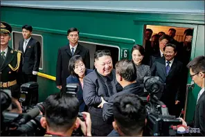  ?? AP/Korean Central News Agency ?? North Korean leader Kim Jong Un (center left) bids farewell to Chinese Communist Party’s Internatio­nal Department head Song Tao (center right) at a station in the Chinese border town of Dandong on Wednesday.