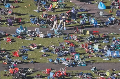  ?? GREGORY BULL/THE ASSOCIATED PRESS ?? FBI agents continue to process evidence Wednesday at the scene of the shooting in Las Vegas, Nev.