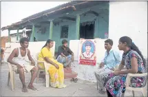  ?? ASSOCIATED PRESS ARCHIVES ?? Family members grieve in May by a portrait of Bala Krishna, a 33-yearold motorized rickshaw driver who was killed by a mob inflamed by social media in Jiyapalli village.