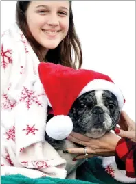  ??  ?? Savannah Young and her pup in the annual Pea Ridge Christmas Parade the first Saturday of December.