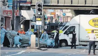  ?? FRANK AUGSTEIN ASSOCIATED PRESS FILE PHOTO ?? In this June 19, 2017 photo, forensic officers move the van which struck pedestrian­s near a mosque at Finsbury Park in north London. Darren Osborne has been found guilty of murder and attempted murder.