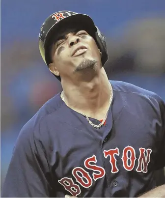  ?? AP PhoTo ?? SORE SUBJECT: Xander Bogaerts grimaces after he was hit by a pitch from Tampa Bay Rays starter Matt Andriese last night in St. Petersburg, Fla.