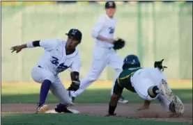  ?? PHOTOS BY MIKE BUSH/NEWS-SENTINEL ?? Above: Tokay second baseman Jaime Quesada waits for the throw to tag out Tracy runner Dylan Angelo in the top of the second inning of Thursday's TCAL baseball game. Angelo was safe, but Quesada scored the winning run in the bottom of the sixth to help...