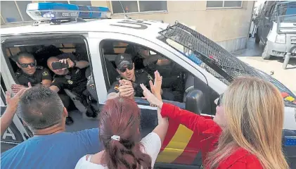  ?? REUTERS ?? Apoyo. Catalanes saludan a policías nacionales cuando parten de su hotel en Pineda del Mar.