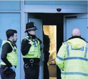  ?? GRIMSBY TELEGRAPH ?? Police raiding the old bank in Grimsby where they discovered a huge cannabis-growing operation