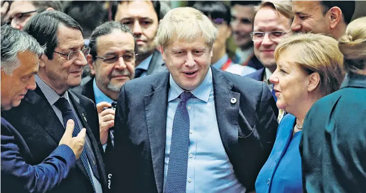  ??  ?? Mr Johnson with, from left, Hungary’s Viktor Orban, Nikos Anastasiad­es of Cyprus and Angela Merkel of Germany before the EU leaders’ summit convened in Brussels yesterday
