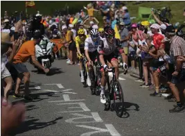  ?? THIBAULT CAMUS — THE ASSOCIATED PRESS ?? Brandon McNulty of the U.S. leads Tadej Pogacar of Slovania and Jonas Vingegaard of Denmark as they climb Peyragudes pass during Wednesday's stage of the Tour de France. Vingegaard holds a lead of 2:18over Pogacar with four stages remaining.