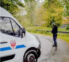  ??  ?? A policeman stands next to a police vehicle near the ‘Centre Zahra France’ religious associatio­n in Grande Synthe near Dunkirk during an operation of ‘terrorism prevention’. — AFP photo