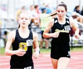  ?? ?? Emma Claire Spradling and Emma Wilson compete in the distance events for the Starkville High School girls track and field team. (Submitted photo)