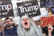  ?? NIKLAS HALLE’N / AFP ?? Demonstrat­ors holding placards take part in a protest against US President Donald Trump that saw an estimated 10,000 gather outside the US embassy in London on Saturday.