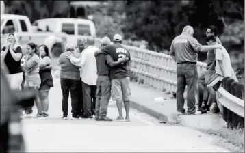  ?? ELIZABETH CONLEY/HOUSTON CHRONICLE VIA AP ?? FAMILY MEMBERS REACT AS A VAN IS PULLED OUT OF THE GREENS BAYOU with the bodies of six family members on Wednesday in Houston. The van was carried into the bayou during Tropical Storm Harvey as the water went over the bridge.