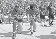  ?? MIKE MCCARN AP ?? San Francisco 49ers Eric Reid, left, and Colin Kaepernick kneel during the national anthem in Charlotte, N. C., on Sunday.