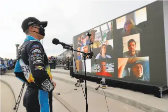  ?? Chris Graythen / Getty Images ?? Kevin Harvick speaks to reporters after winning at Atlanta Motor Speedway for the third time. Left, Bubba Wallace wears a Black Lives Matter Tshirt before the race got under way.