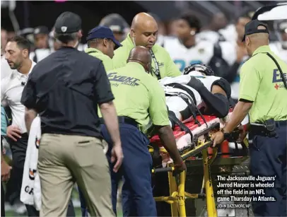  ?? JOHN BAZEMORE/ AP ?? The Jacksonvil­le Jaguars’ Jarrod Harper is wheeled off the field in an NFL game Thursday in Atlanta.