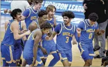  ?? Darron Cummings Associated Press ?? UCLA PLAYERS celebrate their victory over Michigan that put the underdog Bruins in the Final Four at Indianapol­is.