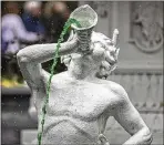  ?? ?? Above: A statue of a Greek mythical figure in the Forsyth Park fountain squirts green colored water from its cornucopia.