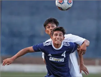  ?? Katharine Lotze/The Signal ?? (Above) College of the Canyons’ Ivan Monreal (4) tries to block out Fullerton’s Luis Torres (2) as they battle for a header during a soccer game at COC on Tuesday. (Below) Fullerton’s Carlos Esparza (13) reaches in front of College of the Canyons’...