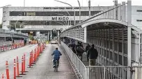  ?? Danny Zaragoza / Laredo Morning Times file photo ?? Pedestrian­s, motorists and cyclists cross the Gateway to the Americas Internatio­nal Bridge in March after travel restrictio­ns were announced.