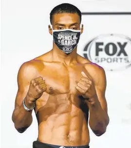  ?? TONY GUTIERREZ AP ?? Boxer Errol Spence Jr., poses during weigh-in for a title match against Danny Garcia. Spence Jr. is putting his WBC and IBF welter weight titles on the line tonight.