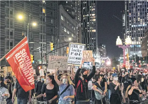  ?? REUTERS ?? People take part in a march following the announceme­nt of a single indictment in the Breonna Taylor case, in the Brooklyn borough of New York City.