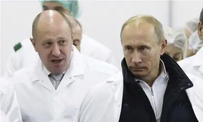  ?? Photograph: Alexei Druzhinin/AP ?? Yevgeny Prigozhin, left, with Vladimir Putin. An online trolling operation based in St Petersburg is believed to be linked to Prigozhin’s Internet Research Agency.