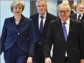  ??  ?? European Commission President Jean-Claude Juncker, British Prime Minister Theresa May and European Union chief Brexit negotiator Michel Barnier (center) walk to their meeting at the European Commission headquarte­rs in Brussels, on Thursday. AP PHOTO/GEERT VANDEN WIJNGAERT