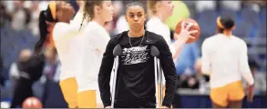  ?? Jessica Hill / Associated Press ?? UConn’s Evina Westbrook, a transfer from Tennessee watches her team warm up as Tennessee players warm up behind her before a game on Jan. 23 in Hartford.