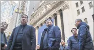  ?? Associated Press ?? Visitors from China take in the view outside the New York Stock Exchange on Tuesday.