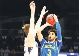  ?? ANDY LYONS GETTY IMAGES ?? BYU’S Matt Haarms tries to guard UCLA’S Johnny Juzang, who scored 27 in the Bruins’ victory.