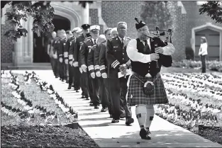  ?? Staff Photo by John Rawlston ?? Bob Scott plays “Amazing Grace” on the bagpipes Monday afternoon as he leads a group of firefighte­rs out of Patten Chapel at the University of Tennessee at Chattanoog­a at the conclusion of a memorial service for victims of the terror attacks of Sept. 11, 2001.