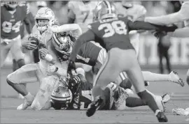  ?? Jed Jacobsohn Associated Press ?? CHARGERS QUARTERBAC­K Justin Herbert is hit by 49ers cornerback Jimmie Ward (1) and linebacker Fred Warner (54) during San Francisco’s 22-16 victory.