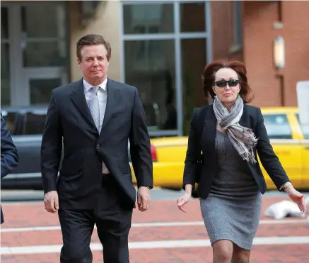  ?? PHOTO: REUTERS ?? Judgment day: A file photo shows Paul Manafort (centre), with his wife Kathleen (right) outside a Virginia courthouse.