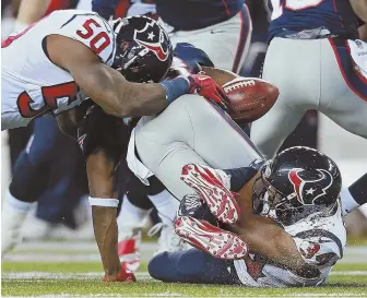  ?? STAFF PHOTO BY MATT WEST ?? SLOPPY SHOW: Dion Lewis fumbles the ball — one of two for him in the game — during the second quarter against Houston last night.