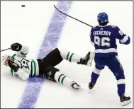  ??  ?? Blake Comeau (left) of the Dallas Stars is checked by Nikita Kucherov of the Tampa Bay Lightning during the the second period of Game 2 of the Stanley Cup Final on Monday in Edmonton, Alberta. The Lightning won 3-2 to even the series at 1-1. (AP/The Canadian Press/Jason Franson)