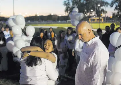  ?? Rachel Aston ?? Las Vegas Review-journal @rookie__rae Shaja Revilla hugs Elena Pineda, the mother of Helena Lagos, next to her husband, Kash Christophe­r, at a vigil for Lagos at Tropical Breeze Park on Friday. Lagos and five others were killed Monday night in a plane...