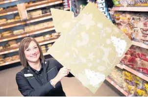  ??  ?? Pictured is Central England Co-operative’s Lisa Hollis who was all smiles after customers in Leicesters­hire collected over 60,000 items as part of the Christmas Foodbank Appeal.