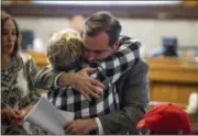  ?? MEG VOGEL — THE CINCINNATI ENQUIRER VIA AP ?? Cincinnati Mayor John Cranley hugs a member of Kyle Plush’s family before council’s Law and Public Safety Committee meeting where Kyle Plush’s death after he accidental­ly got pinned in the fold-away back seat of a minivan was discussed inside the...