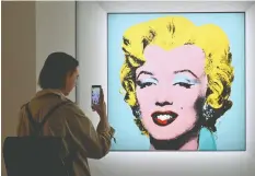  ?? — GETTY IMAGES FILES ?? The silkscreen print “Shot Sage Blue Marilyn” by Andy Warhol has set a record for a work by an American artist sold at auction.