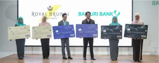  ??  ?? Staff of Baiduri Bank and Royal Brunei Airlines seen holding the mocks of the newly launched Royal Brunei Visa Debit and Credit Cards by Baiduri Bank. Images: Fazizul Haqimie