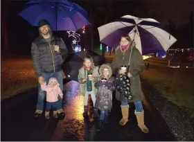  ??  ?? The Ziegler family of Exeter Township, Doug and Alli, and their daughters, Brooke, 7, Quinn, 5, and Olivia, braved the cold rain Friday for opening night of Holiday Lights at Gring’s Mill Recreation Area.